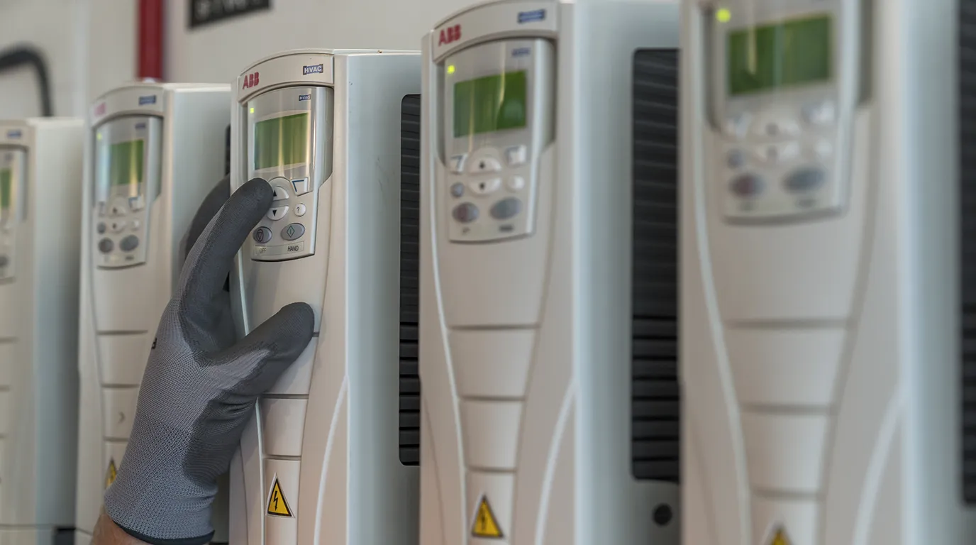 person pressing buttons on a control panel